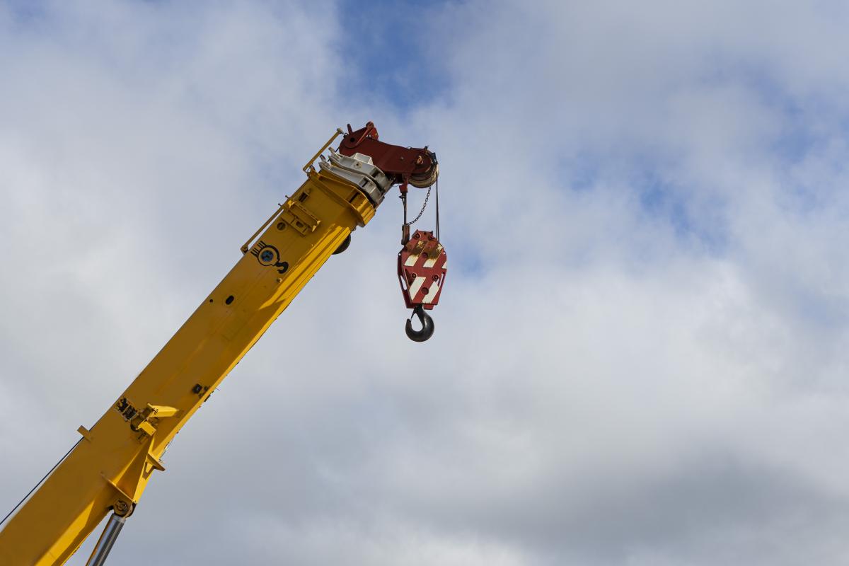 Photo of a hoist crane hook with sky background