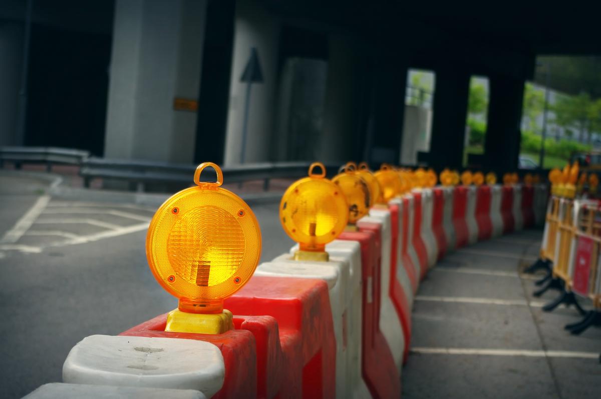 Photos of traffic management barricades on the side of a road